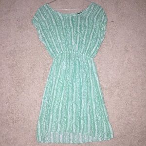 Turquoise dress with white details/patterns